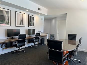 A conference room with a long table and chairs.